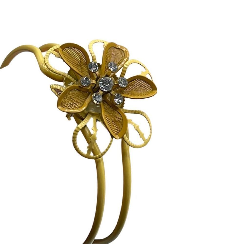 Vintage mustard metal cuff bracelet with rhinestone flower.